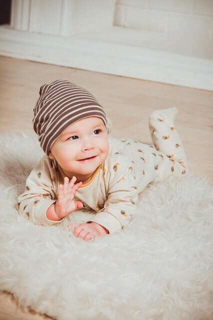 Baby smiling laying on the floor